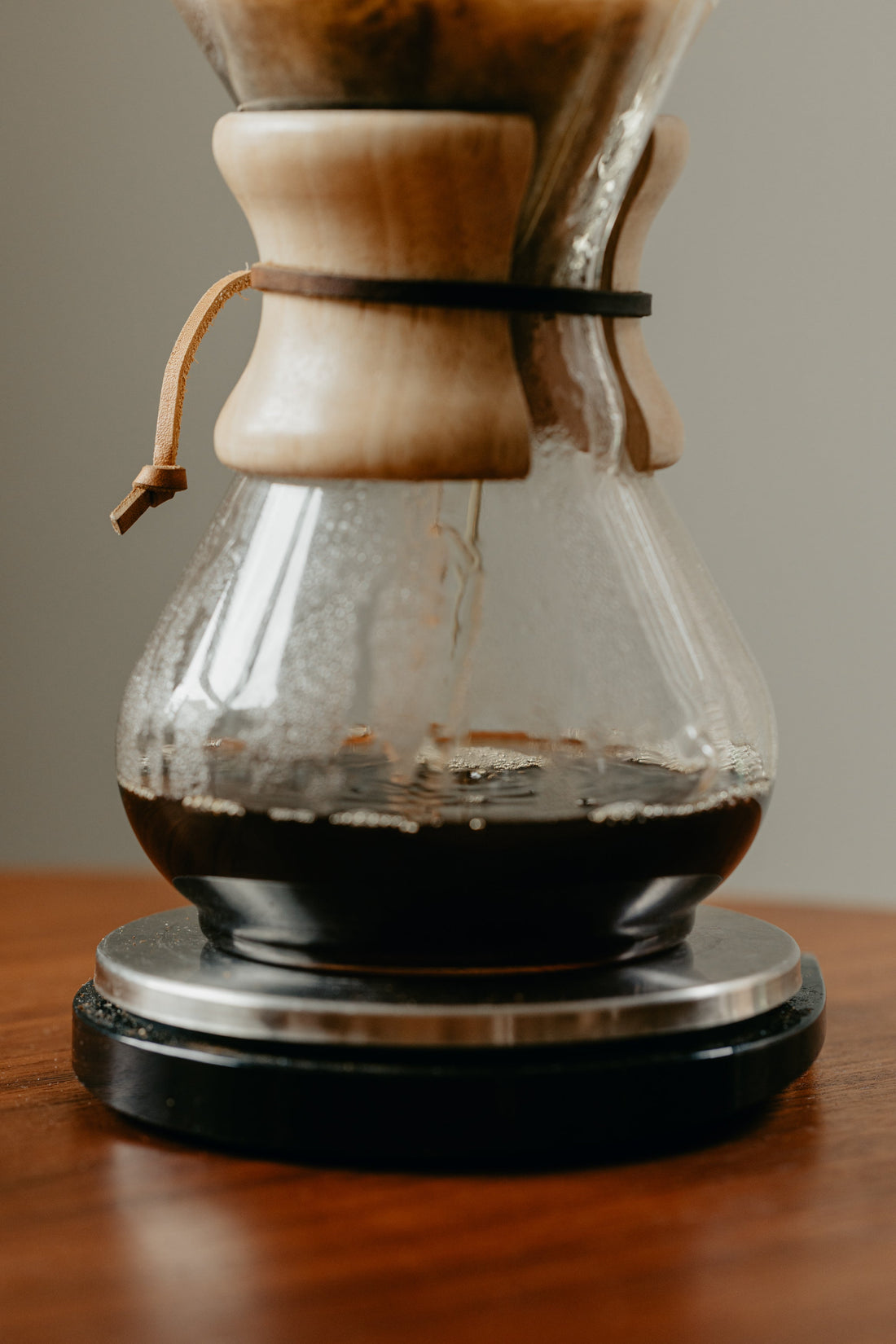 A chemex coffee brewer on a wooden table