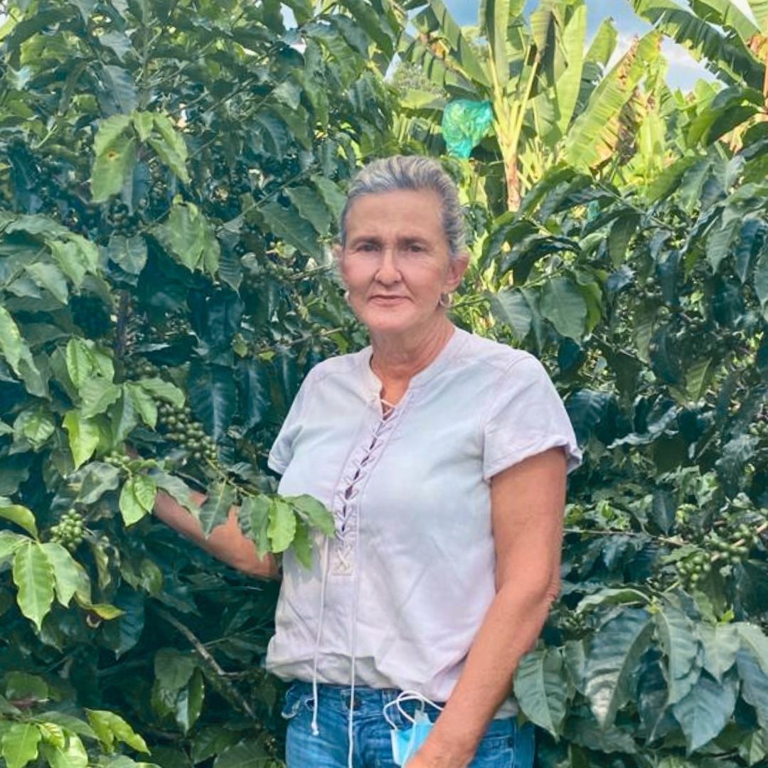 Luz Helena Salazar standing among coffee trees