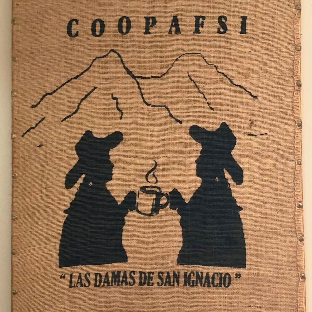 Coffee jute bag with silhouette of two women drinking coffee and mountain, featuring 'COOPAFSI' and 'Las Damas de San Ignacio'.