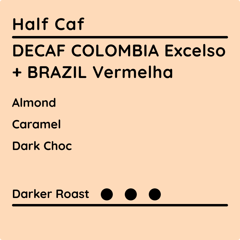 Half Caf Decaf Colombia Excelso + Brazil Vermelha coffee label showing tasting notes of almond, caramel, and dark chocolate with a darker roast.