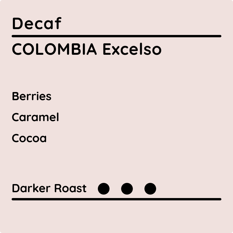 Decaf Colombia Excelso coffee label showing tasting notes of berries, caramel, and cocoa with a darker roast